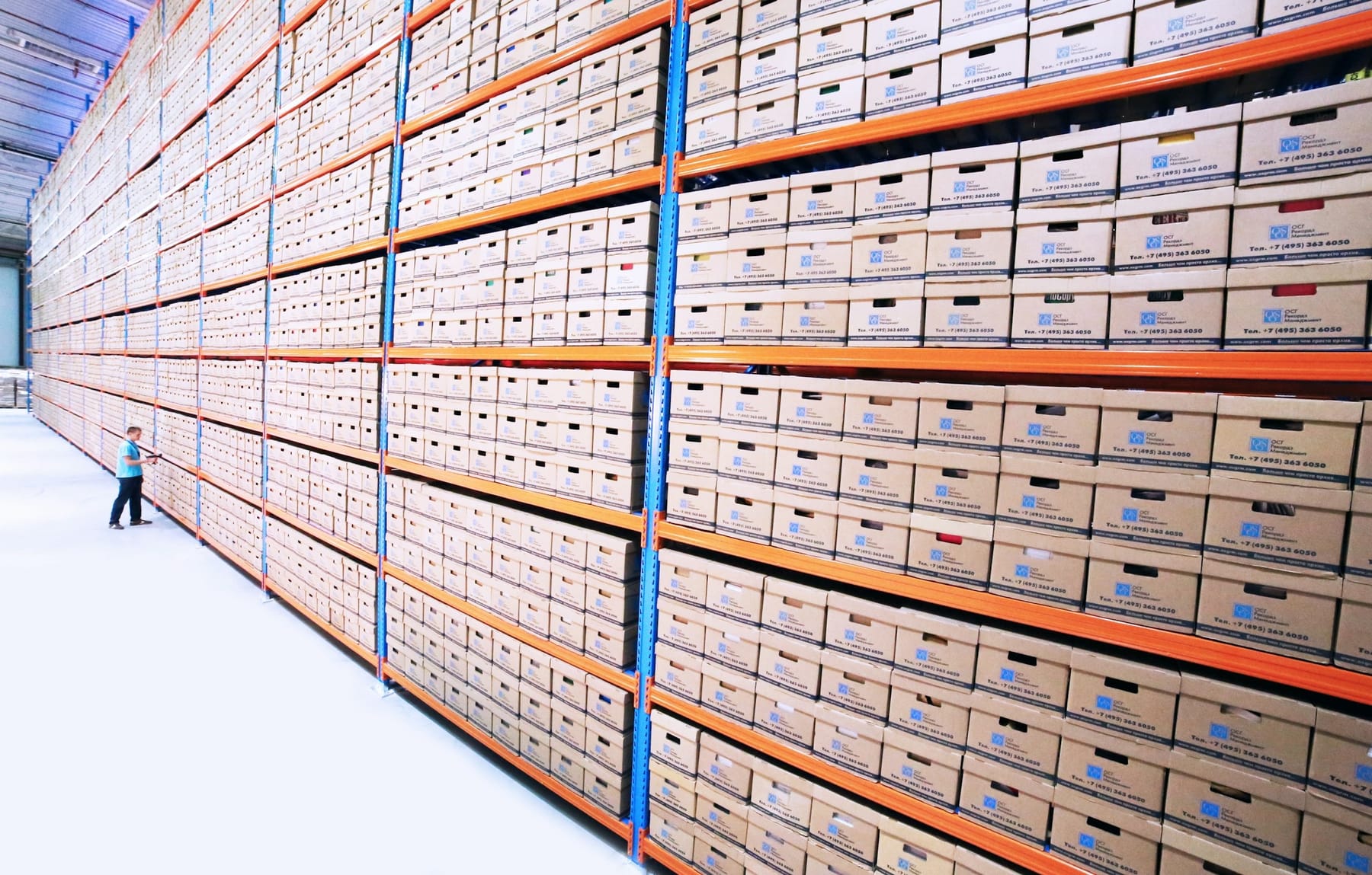 Racking filled with hundreds of labelled archive boxes, seen along the shelves.