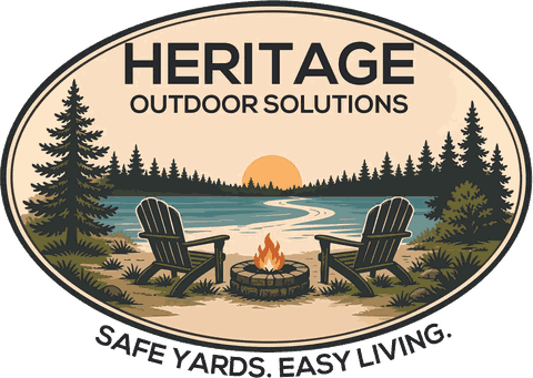 Heritage Outdoor Solutions — an oval badge showing two Adirondack chairs beside a fire pit on a lake shore, framed by pines, over the line “Safe Yards. Easy Living.”